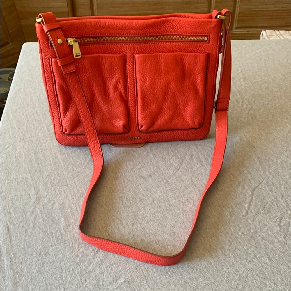Fossil, leather crossbody bag with brass hardware.